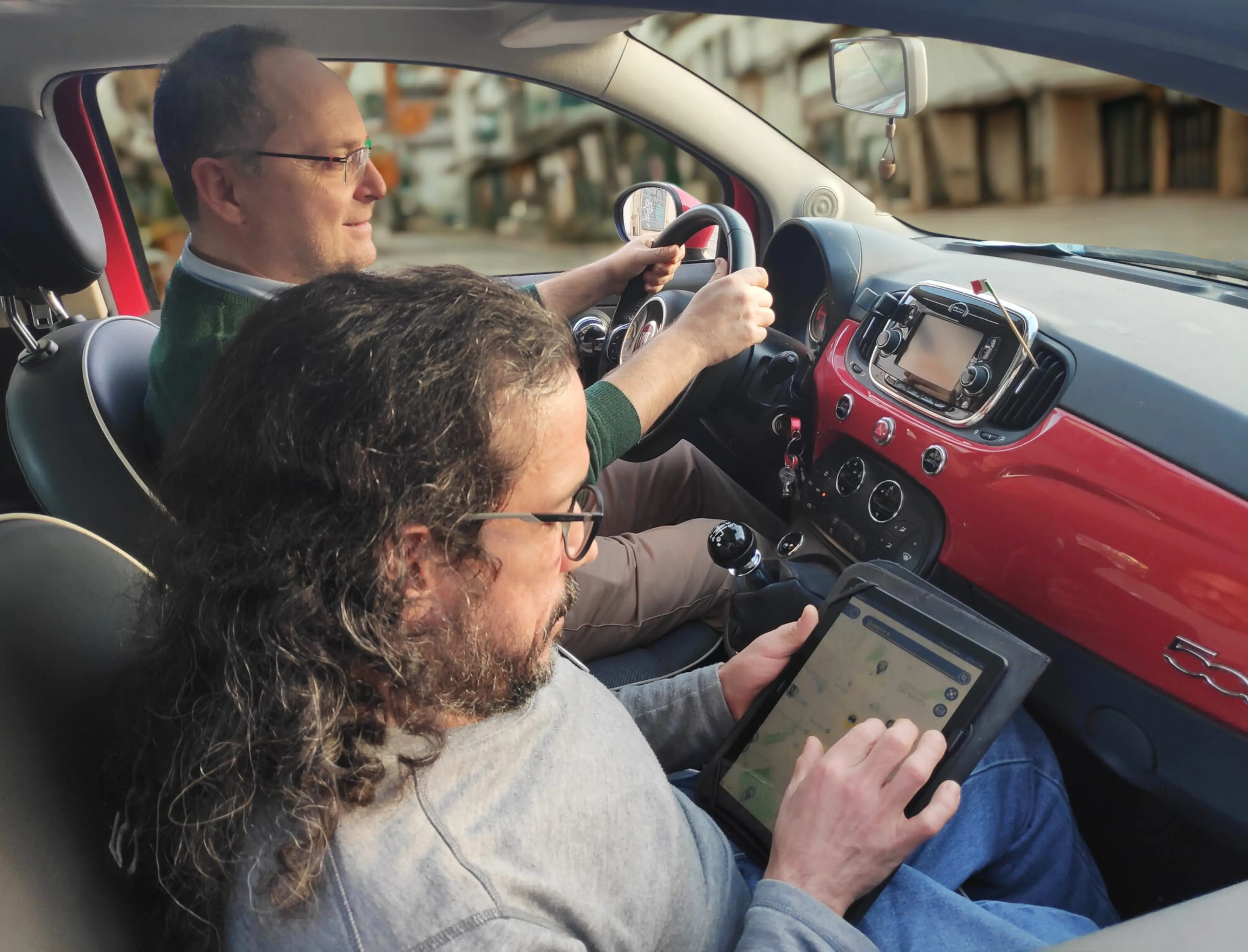 Presidente Carlo mostrando la funcionalidad de la App Spot4Dis a un acompañante dentro de un vehiculo en movimiento